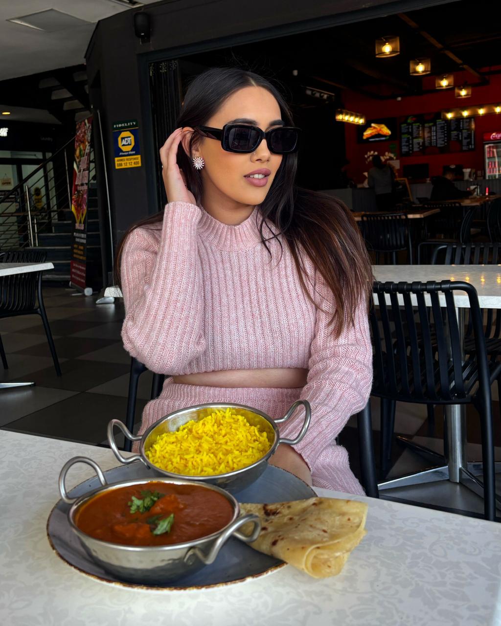Guest dining with a plated curry meal