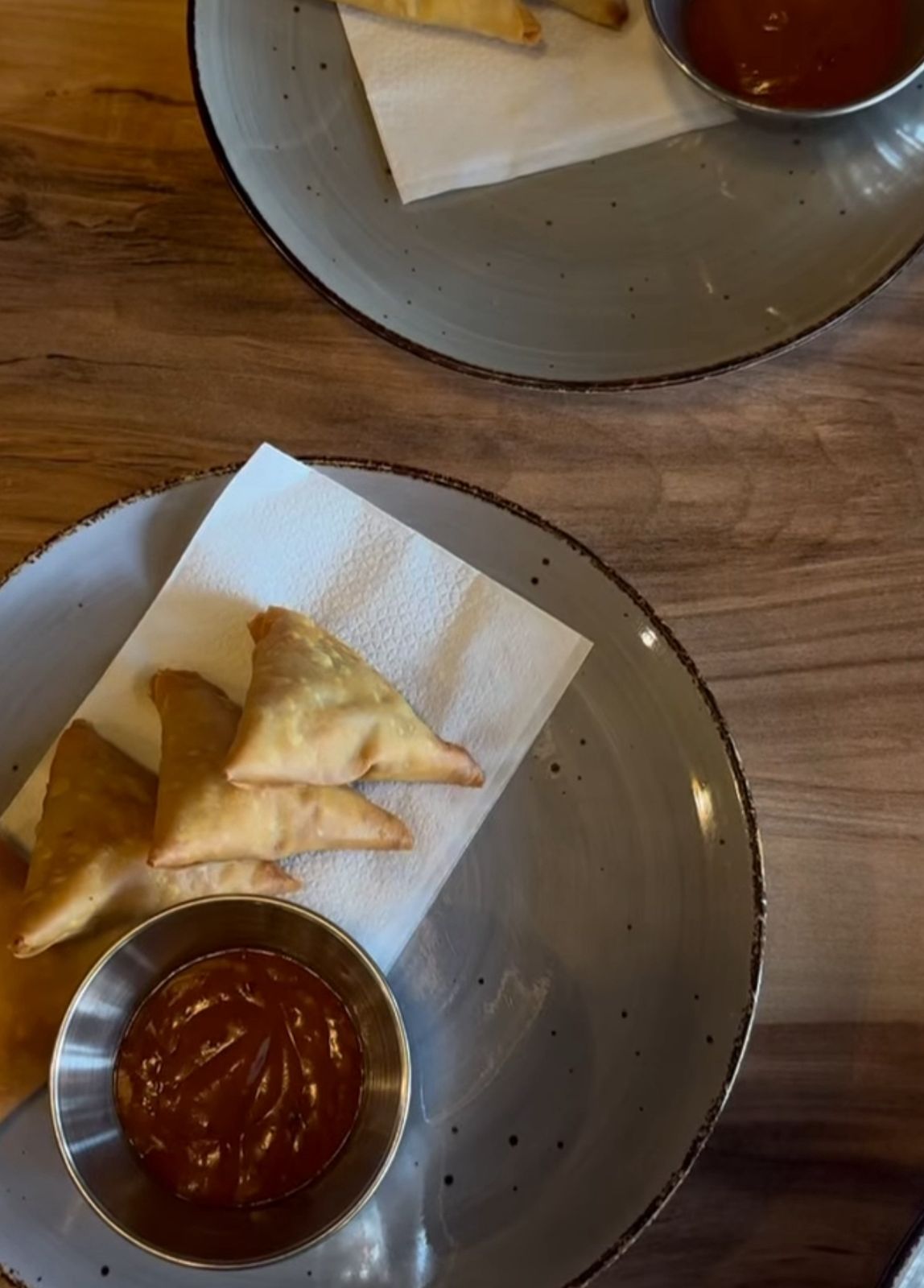 Samosas plated with sauce