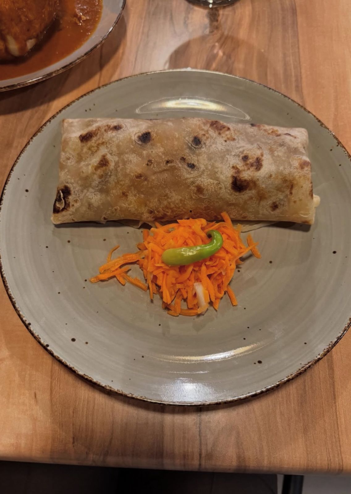 Roti plated with carrot garnish
